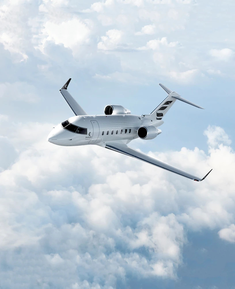 Private jet flying above clouds